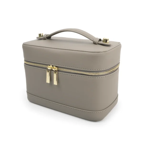 CHICCASEN Vanity Case in Elephant Grey, photographed closed from a three-quarter angle with its curved handle and gold-tone double zip visible.